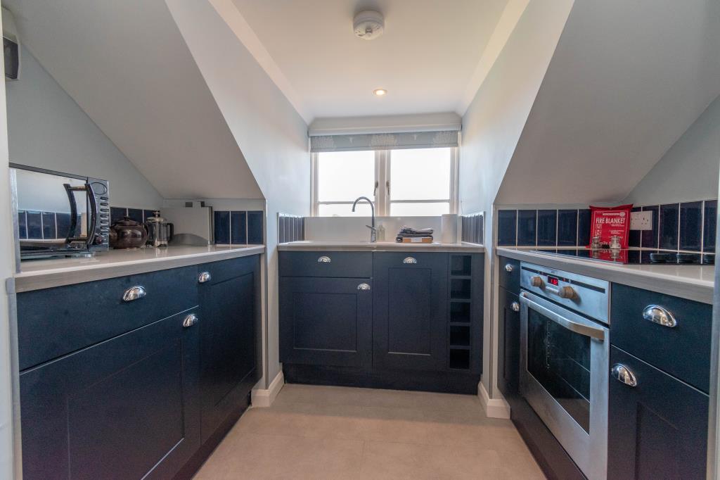 Lot: 29 - CHARACTERFUL FLAT IN A DESIRABLE NORFOLK COASTAL TOWN - Fitted Kitchen with Window to the rear